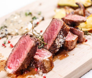 Beef steak on a wooden board, fine dining